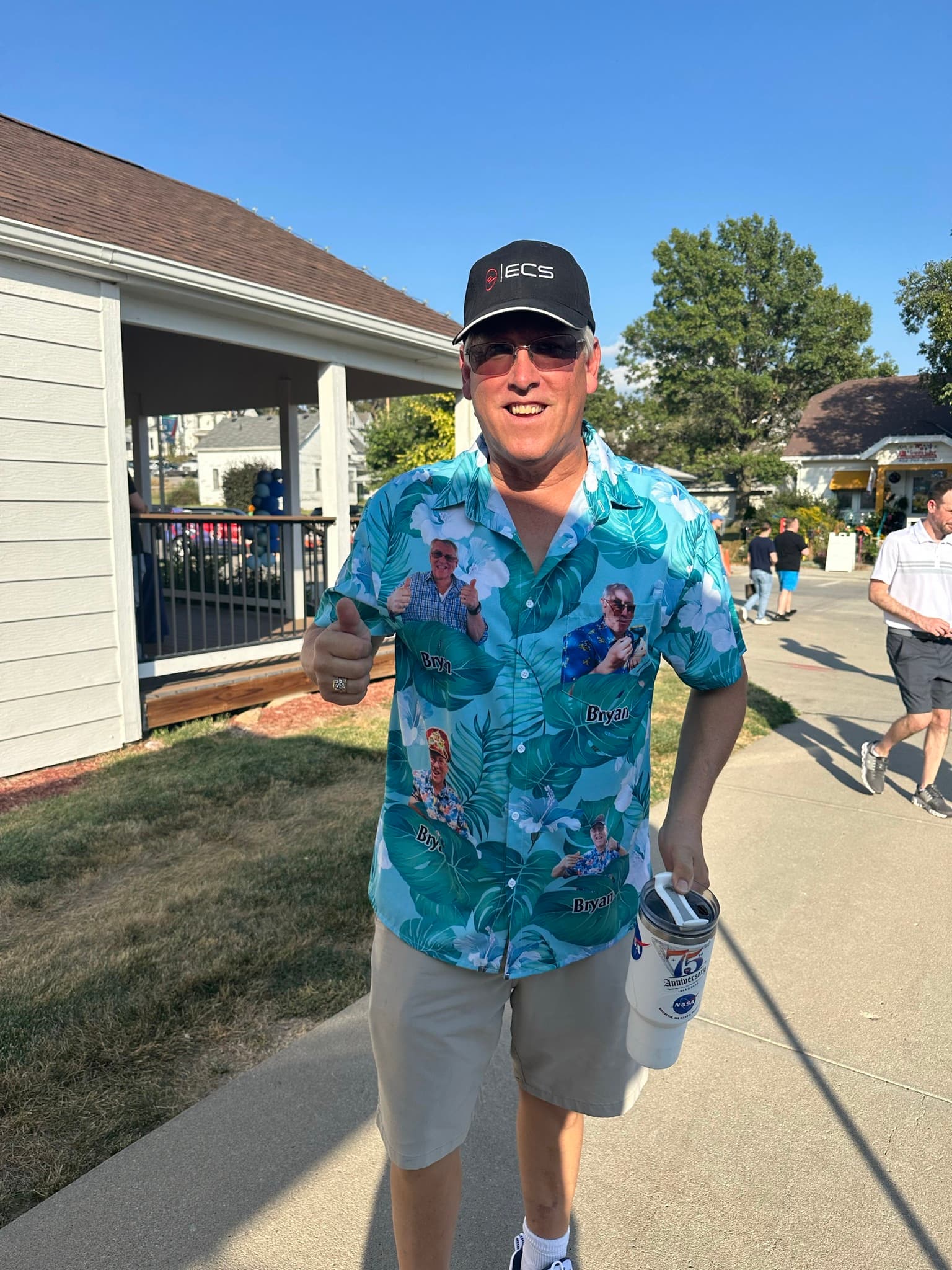 A guest in a custom Hawaiian shirt giving a thumbs up on 206th Street