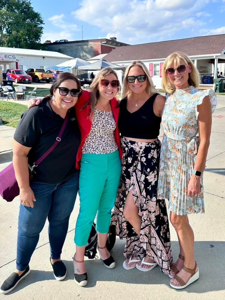 Four guests posing together in the sunshine at BruBash